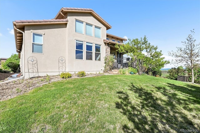 2373 S Joyce St, Denver, CO 80228 - rear view of property featuring stucco siding and a tiled roof