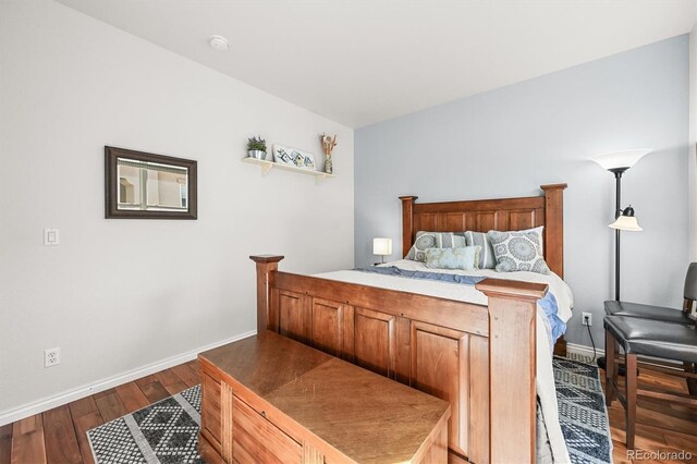 2373 S Joyce St, Denver, CO 80228 - bedroom featuring baseboards and wood finished floors