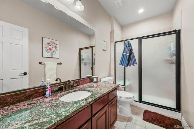 2373 S Joyce St, Denver, CO 80228 - full bathroom with a shower stall, toilet, tile patterned flooring, and vanity