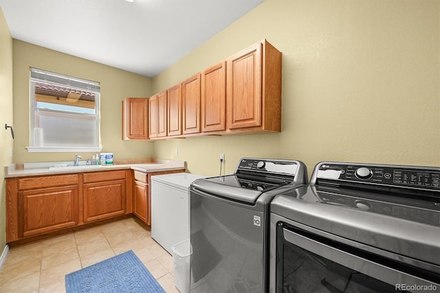 2373 S Joyce St, Denver, CO 80228 - washroom featuring separate washer and dryer, light tile patterned floors, and cabinet space
