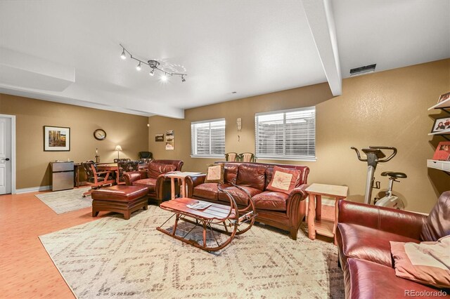 2373 S Joyce St, Denver, CO 80228 - living area with beam ceiling, wood finished floors, and baseboards