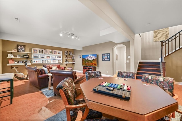 2373 S Joyce St, Denver, CO 80228 - dining room featuring arched walkways, stairway, built in shelves, baseboards, and wood finished floors