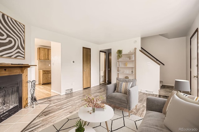3021 11th Ave Unit 15, Evans, CO 80620 - living area with wood finished floors, a fireplace with flush hearth, and baseboards