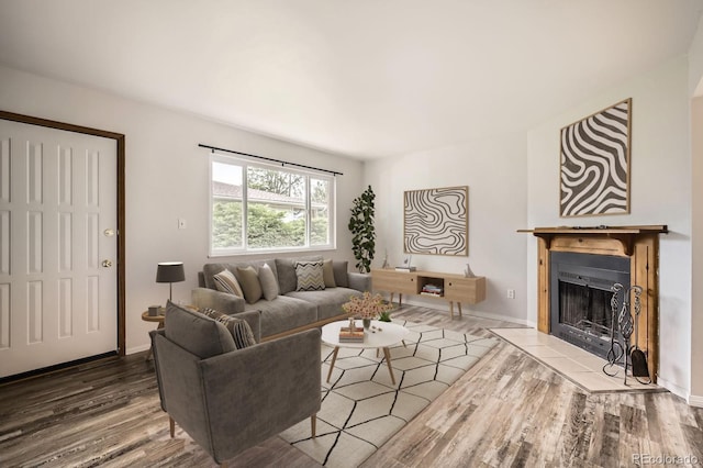 3021 11th Ave Unit 15, Evans, CO 80620 - living room featuring wood finished floors, a fireplace, and baseboards