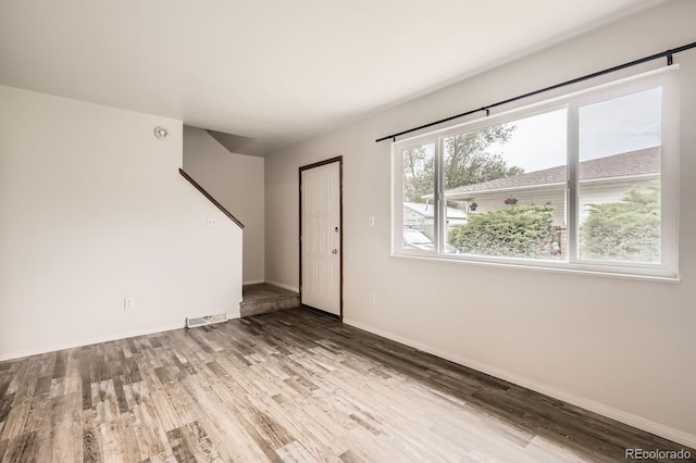 3021 11th Ave Unit 15, Evans, CO 80620 - unfurnished living room featuring wood finished floors and baseboards