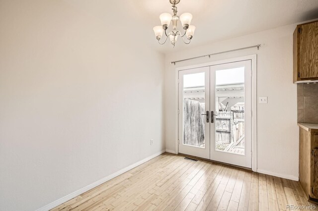 3021 11th Ave Unit 15, Evans, CO 80620 - unfurnished dining area featuring french doors, baseboards, and a chandelier