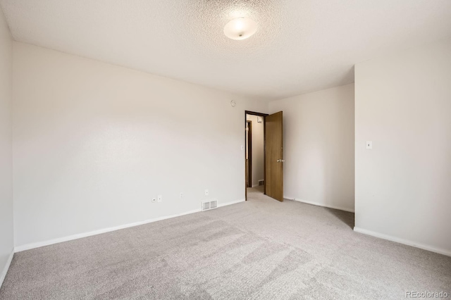 3021 11th Ave Unit 15, Evans, CO 80620 - empty room featuring light colored carpet, a textured ceiling, and baseboards
