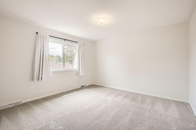 3021 11th Ave Unit 15, Evans, CO 80620 - spare room with light colored carpet, a textured ceiling, and baseboards
