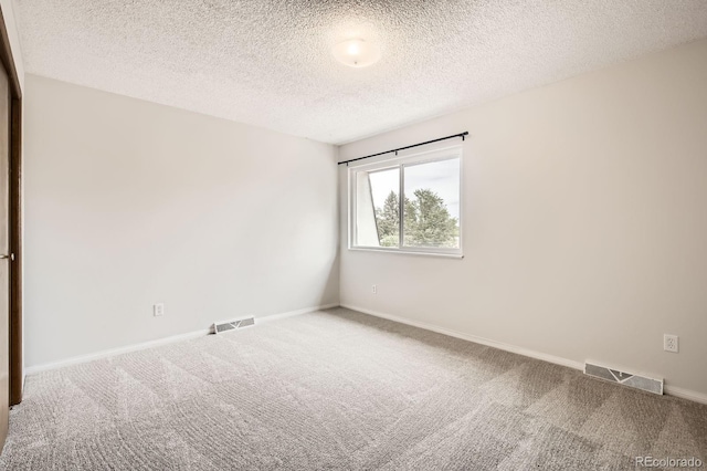 3021 11th Ave Unit 15, Evans, CO 80620 - spare room with carpet floors, a textured ceiling, and baseboards