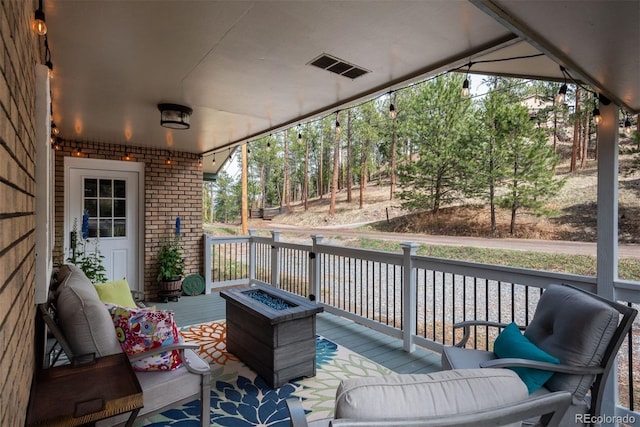 5382 S Pine Rd, Evergreen, CO 80439 - deck with an outdoor living space with a fire pit