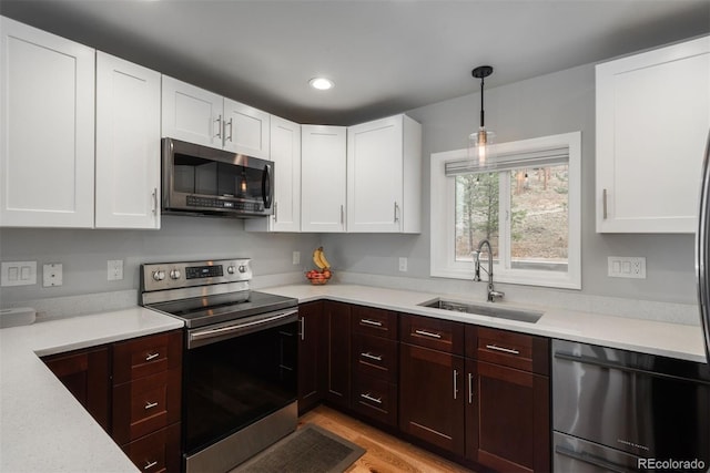 5382 S Pine Rd, Evergreen, CO 80439 - kitchen with stainless steel appliances, a sink, light countertops, white cabinets, and recessed lighting