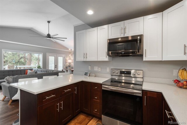 5382 S Pine Rd, Evergreen, CO 80439 - kitchen featuring appliances with stainless steel finishes, light countertops, a peninsula, lofted ceiling, and open floor plan