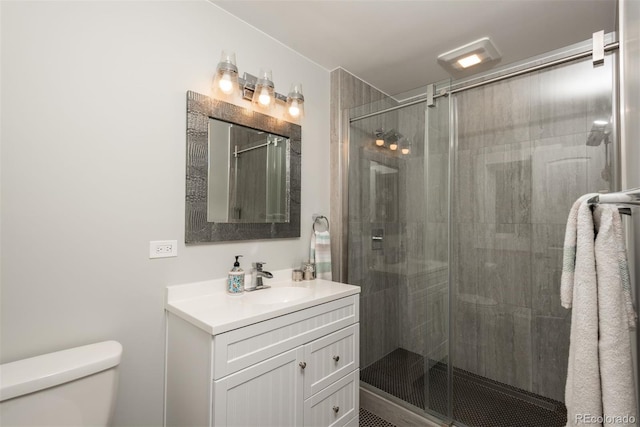 5382 S Pine Rd, Evergreen, CO 80439 - bathroom featuring toilet, a stall shower, and vanity