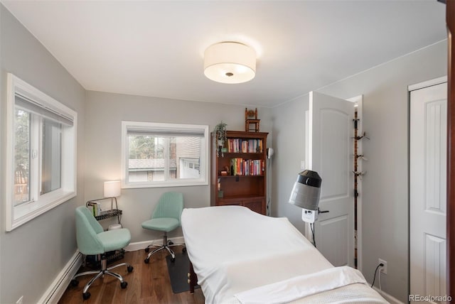 5382 S Pine Rd, Evergreen, CO 80439 - bedroom featuring baseboard heating, wood finished floors, and baseboards