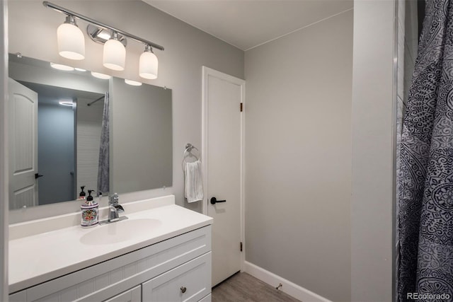 5382 S Pine Rd, Evergreen, CO 80439 - full bathroom with vanity, wood finished floors, baseboards, and a shower with curtain