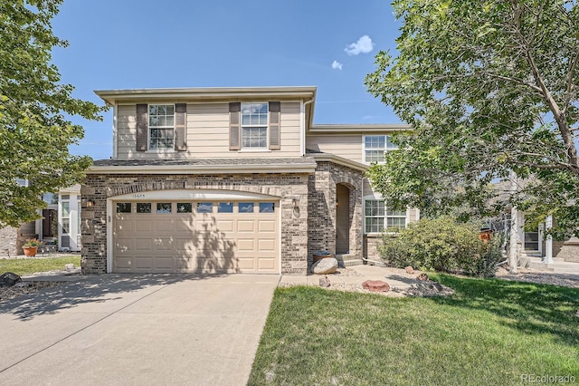 view of front of home with a front lawn, brick siding, an attached garage, and driveway