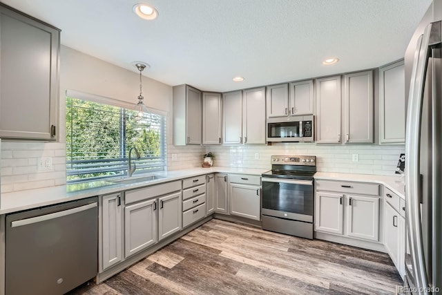 kitchen featuring gray cabinets, appliances with stainless steel finishes, and a sink