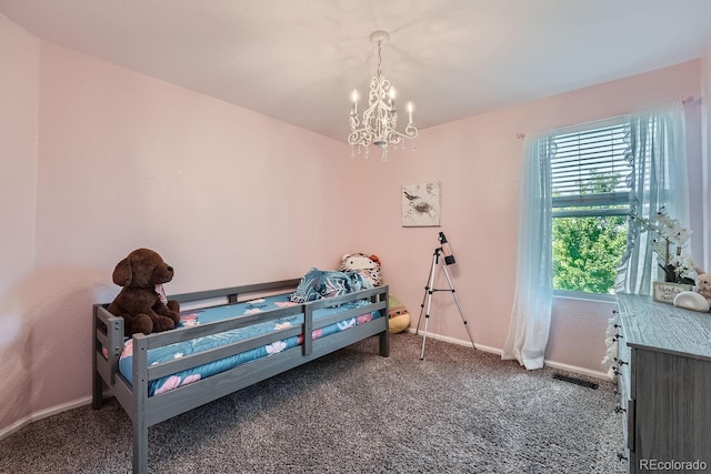 bedroom with visible vents, baseboards, a notable chandelier, and carpet flooring