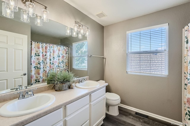 full bath with visible vents, baseboards, and a sink