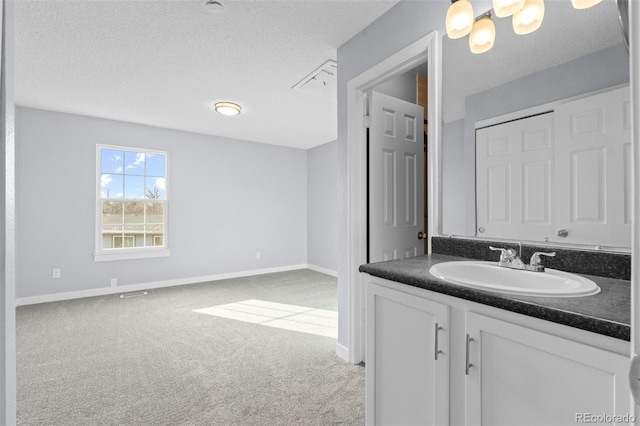 bathroom featuring a textured ceiling and sink