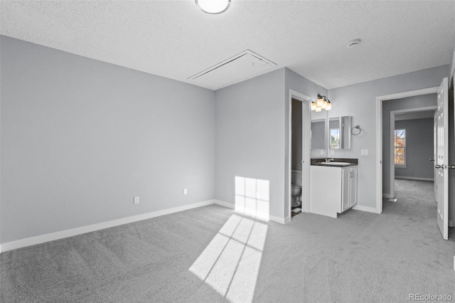 interior space with vanity, a textured ceiling, and toilet