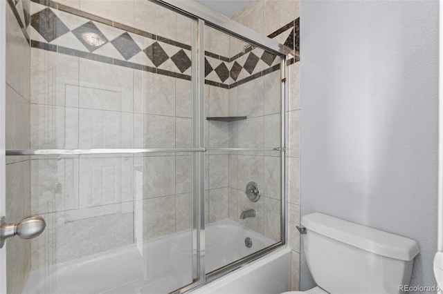 bathroom featuring toilet and enclosed tub / shower combo