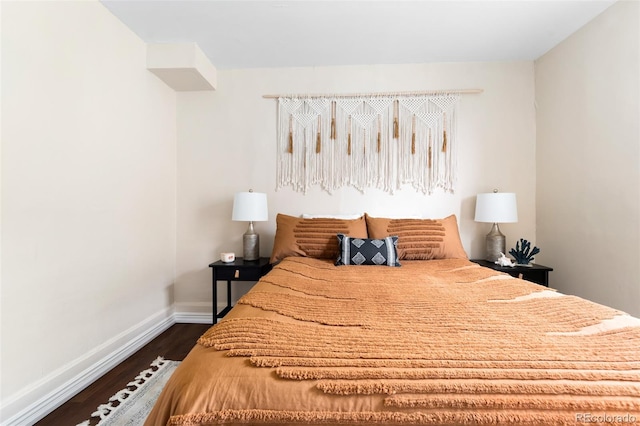 bedroom with dark hardwood / wood-style floors