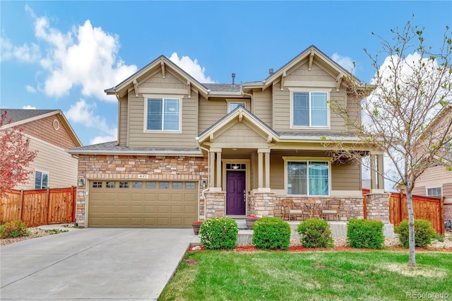 craftsman inspired home with an attached garage, stone siding, concrete driveway, and fence