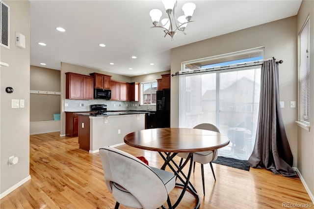 dining room featuring light wood-style floors, recessed lighting, a chandelier, and baseboards