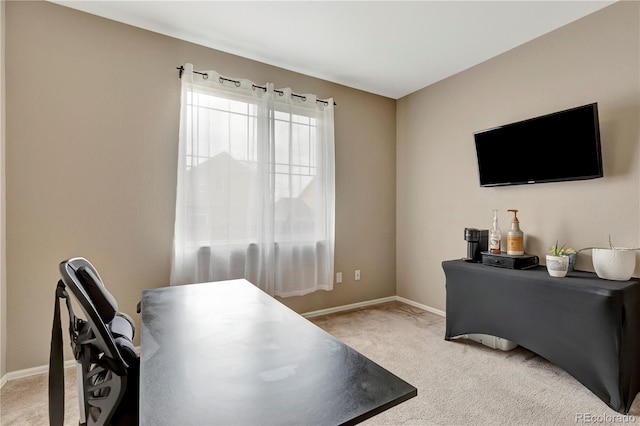 office space with baseboards and light colored carpet