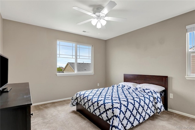 bedroom with ceiling fan, carpet, visible vents, and baseboards