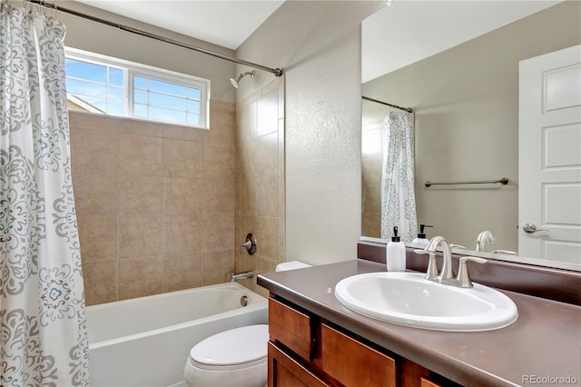 bathroom featuring shower / tub combo, vanity, and toilet