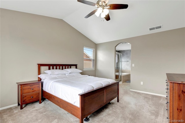 bedroom with baseboards, visible vents, arched walkways, light colored carpet, and lofted ceiling