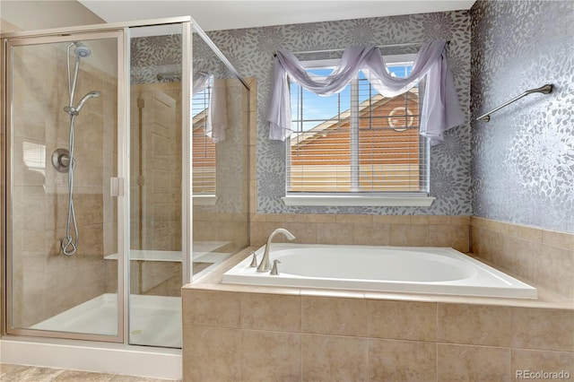 full bathroom featuring a shower stall, a bath, and wallpapered walls