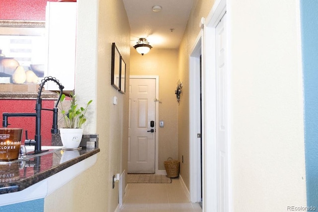 hall with light tile patterned flooring