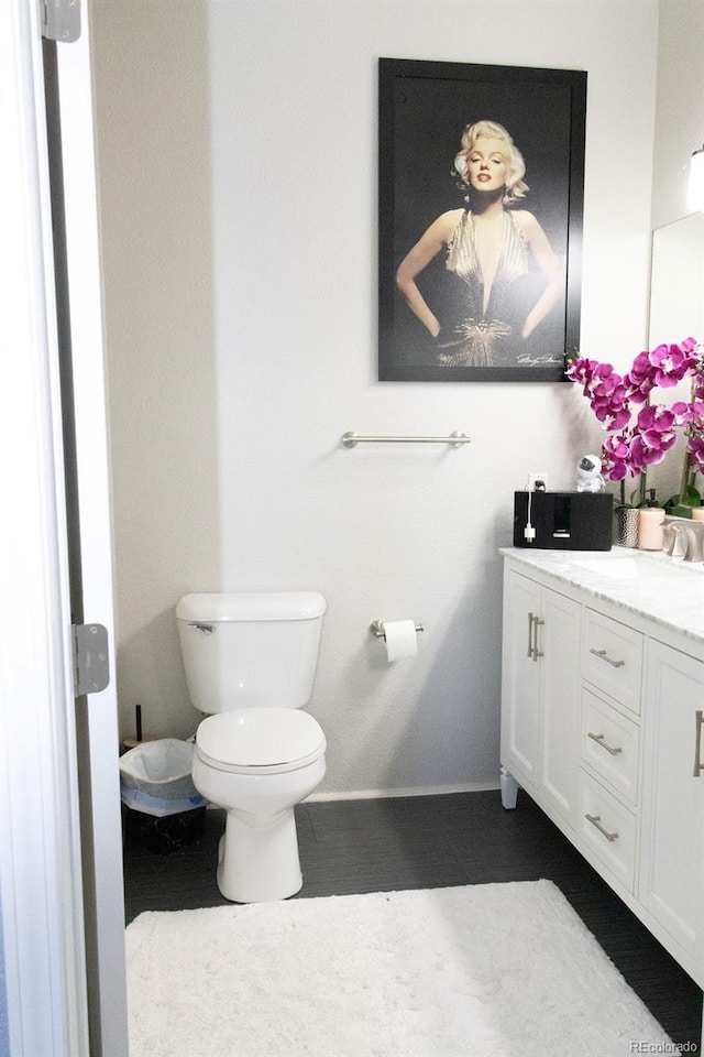 bathroom featuring vanity and toilet