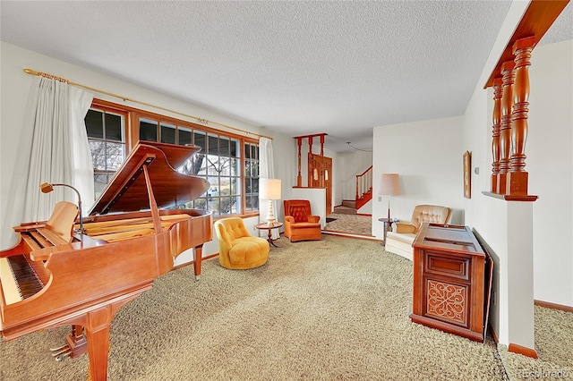 sitting room featuring carpet, stairway, a textured ceiling, and baseboards