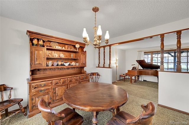 dining area featuring a chandelier, light carpet, and a textured ceiling