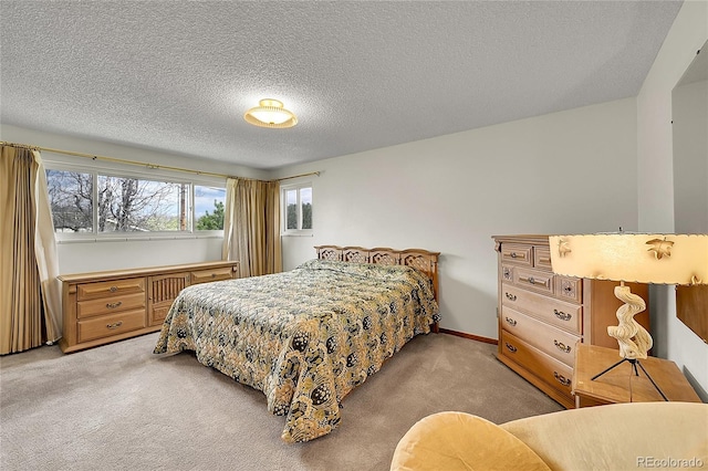bedroom with light carpet and a textured ceiling