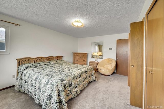 bedroom featuring light colored carpet and a textured ceiling