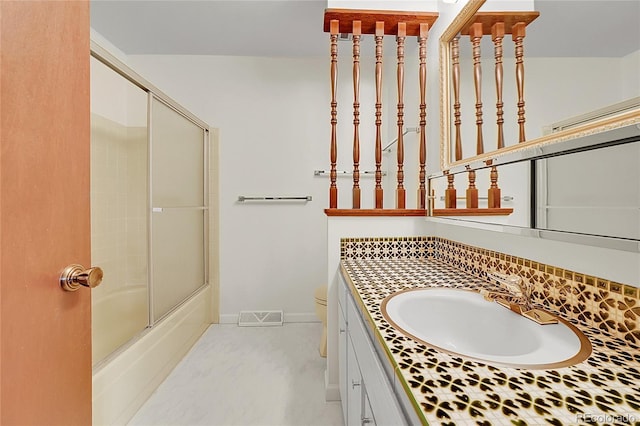 full bath featuring vanity, enclosed tub / shower combo, and toilet