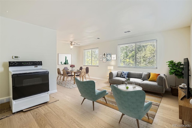 living room featuring light hardwood / wood-style flooring and ceiling fan