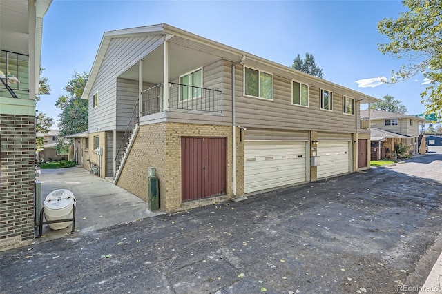 view of front of home with a balcony and a garage