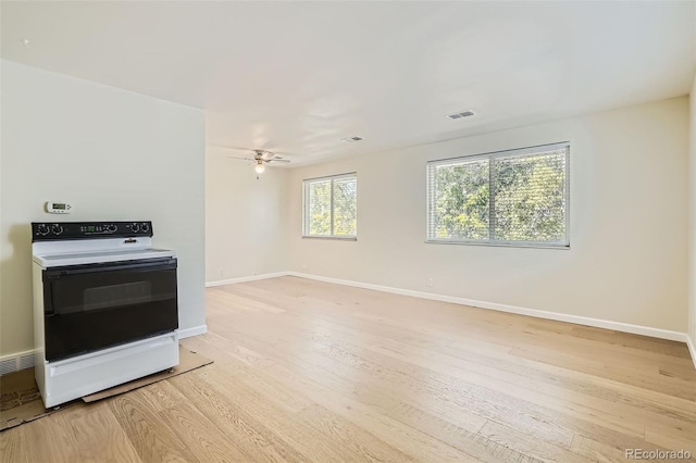 kitchen featuring ceiling fan, light hardwood / wood-style floors, and white range with electric stovetop