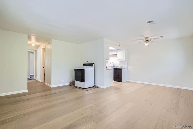 unfurnished living room featuring ceiling fan and light wood-type flooring