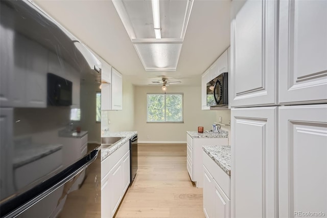 kitchen featuring light wood-type flooring, black appliances, ceiling fan, light stone countertops, and white cabinetry