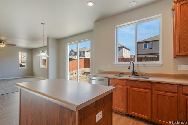 kitchen featuring dishwasher, a kitchen island, sink, and plenty of natural light