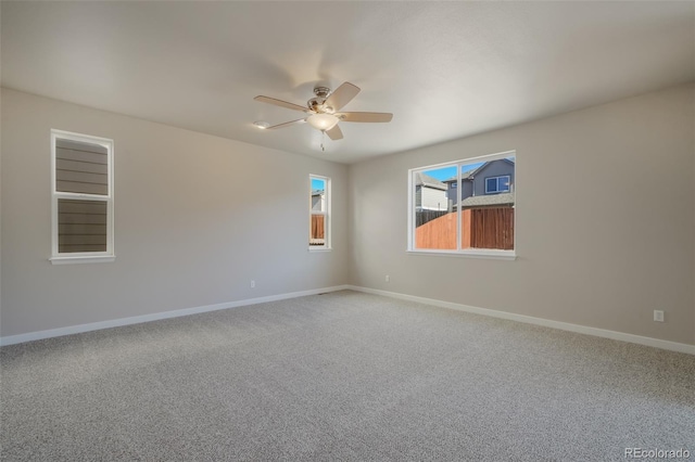 spare room with ceiling fan and carpet