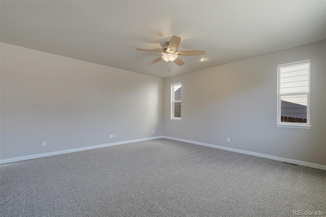 carpeted empty room featuring ceiling fan and a healthy amount of sunlight