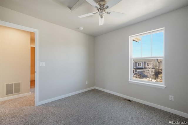 carpeted spare room with ceiling fan